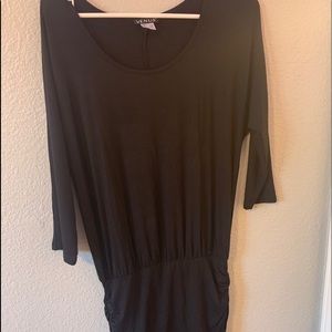 black dress scrunches at bottom